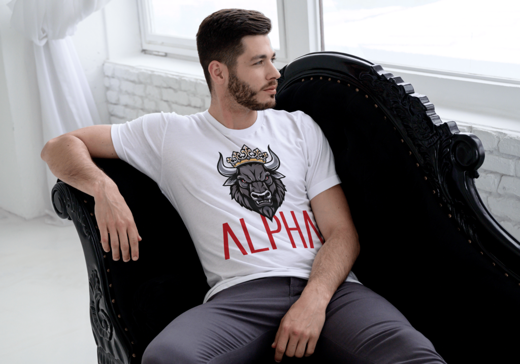 Athletic male wearing white Alpha shirt with bull face and bold red font.